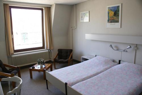 Un ou plusieurs lits dans un hébergement de l'établissement Hotel Domstad