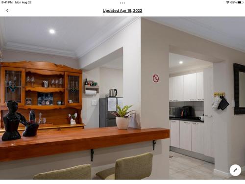 a kitchen with a wooden counter top in a room at Rueby’s Apartment 101 in Dullstroom