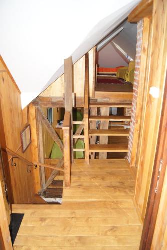 a staircase in a tiny house with wooden walls at Guest House Glogovac in Kamenica