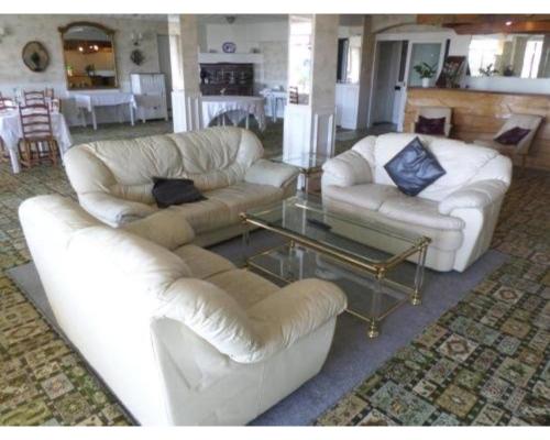 a living room with two white couches and a glass table at Savoy B&B in Weston-super-Mare