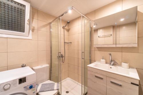 a bathroom with a shower and a toilet and a sink at Diamond Suite in Kanoni
