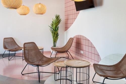 a row of chairs and tables in a waiting room at B&B HOTEL Porto Expo Aeroporto in Matosinhos