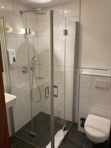 a bathroom with a shower and a toilet at Hotel Biedermeier in Dortmund