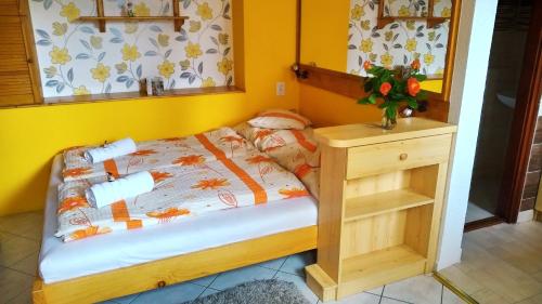 Dormitorio pequeño con cama y mesa con espejo en Csobogó Vendégház, en Eger