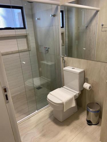 a bathroom with a toilet and a glass shower at HOTEL CORTESE in Teresina