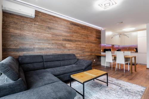a living room with a couch and a table at New Stylish 1-bedroom Flat in Business District in Sofia