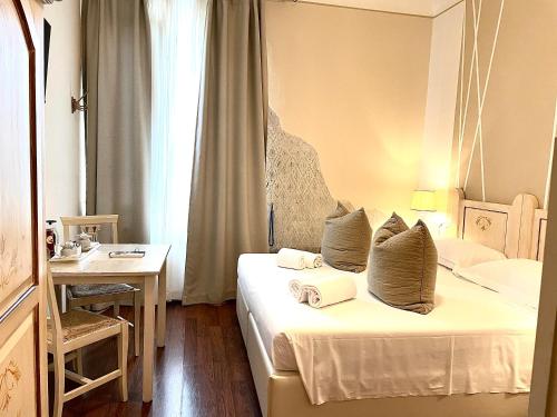 a hotel room with a bed with towels on it at Soggiorno Pezzati in Florence