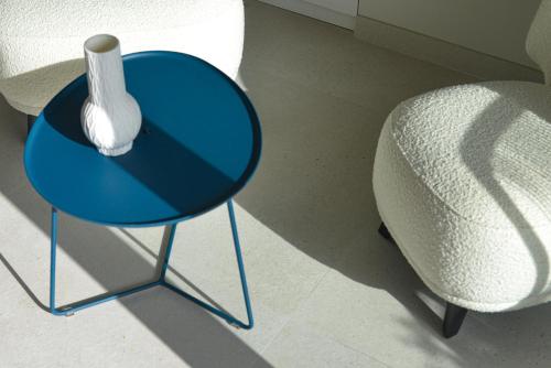 a blue table with a vase on it next to a chair at Le Martin Boutique Hôtel in Cul de Sac