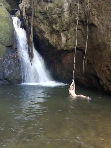 a person in the water in front of a waterfall at Bluestudio in Lumiar