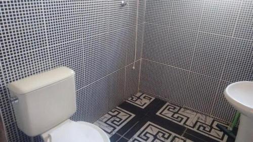 een badkamer met een wit toilet en een wastafel bij Chácara Recanto do Sossego em Mairinque-SP in Aluminio