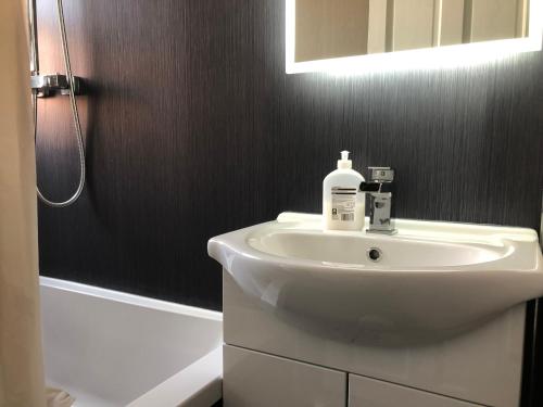 a bathroom with a white sink and a shower at Captivating 2-Bed Apartment in Kirkcaldy in Kirkcaldy