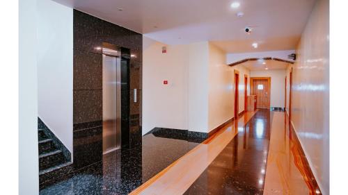 a hallway with black and white tiles on the walls at Hotel DC Star in Tarapith