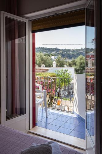 a sliding glass door with a view of a balcony at Hotel Costa Citara in Ischia