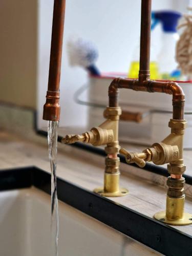 a stream of water coming out of a sink at Beech Tree Cottage in glenwherry