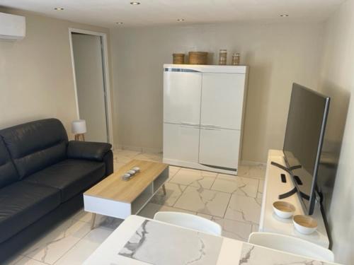 un salon avec un canapé et une table dans l'établissement Mazet proche plage, au Cap d'Agde