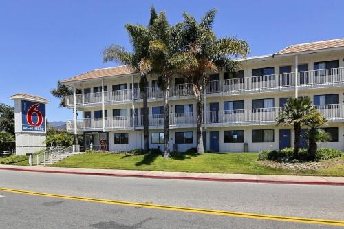 a building with palm trees in front of a street at Motel 6-Carpinteria, CA - Santa Barbara - North in Carpinteria