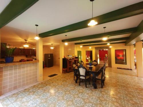 a kitchen and dining room with a table and chairs at DONPIN8-Timeless House Chiang Mai in Chiang Mai