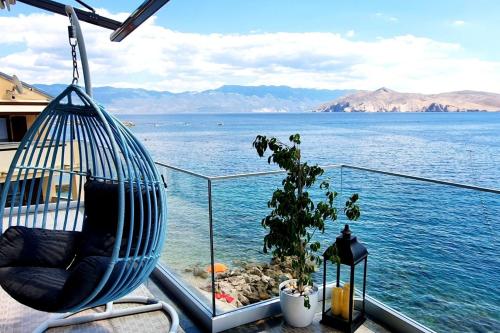 a balcony with a view of the water at Apartments Palada 1 in Baška