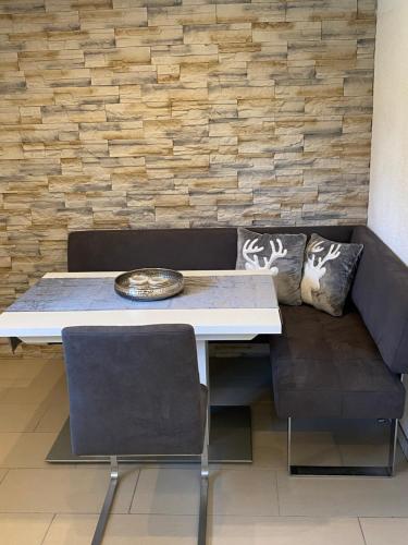 a table and two chairs and a couch in a room at Apartment „AlpView“,Tirol mit Sauna und Pool in Vomp