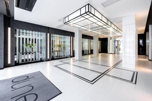 a lobby with a sign on the floor of a building at Dune Beach Resort - C in Mielno