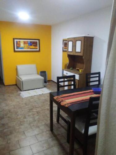 a living room with a table and a couch at Departamento Nueva Córdoba in Cordoba