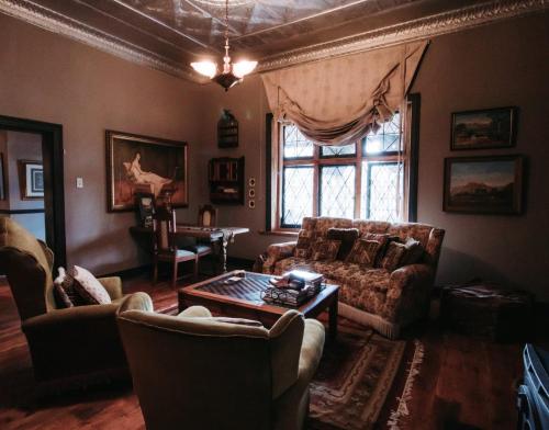 a living room with a couch and a table at Grewar House in Parys
