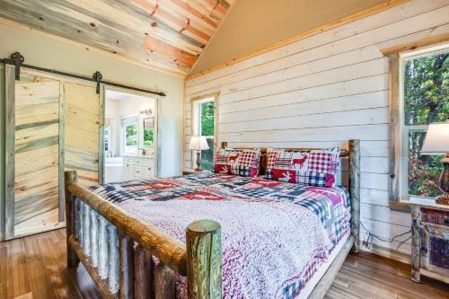 a bedroom with a bed in a room with wooden walls at Lofty Escape in Ellijay