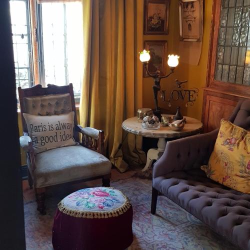 a living room with a couch and a table at Grewar House in Parys