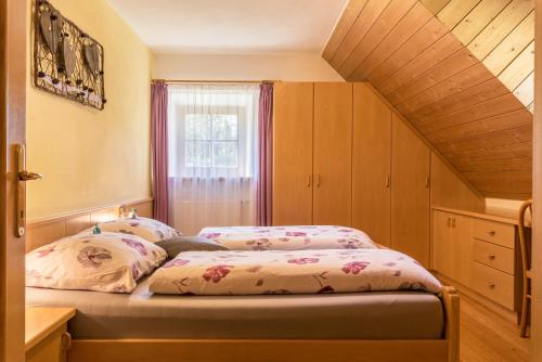 a bedroom with two beds and a window at Oberwieserhof App 1 in San Lorenzo di Sebato