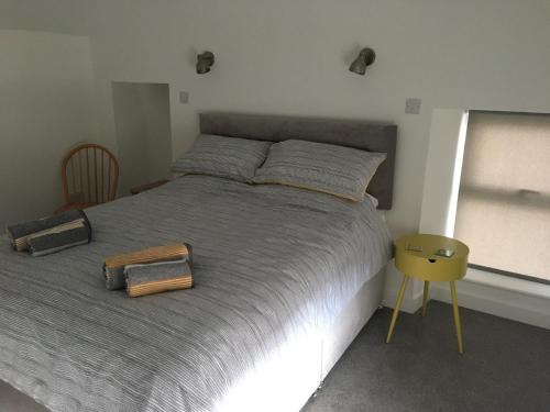 a bedroom with a large bed with two bags on it at Kings Cottage, Nairn - a charming place to stay in Nairn