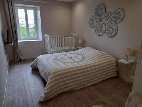 Habitación pequeña con cama y ventana en Gîte de charme Les Prunes de la Souleuvre, en Le Reculey