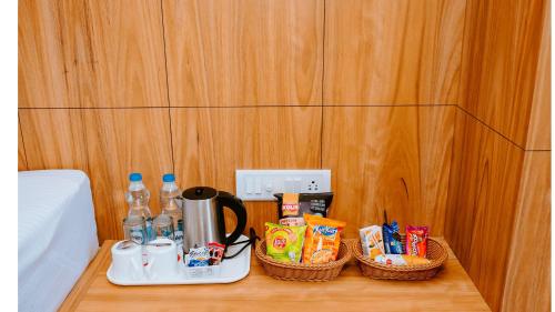 a table with two baskets of food and drinks on it at Hotel DC Star in Tarapith