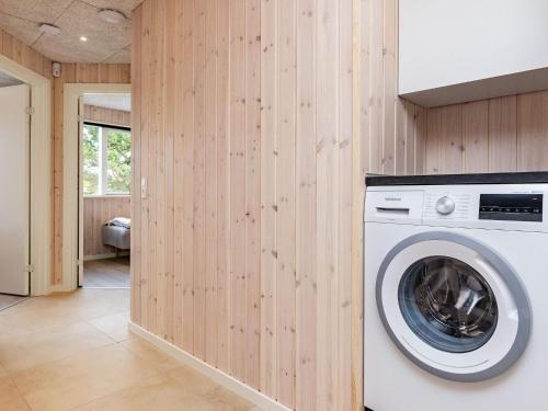 a washing machine in a room with wooden walls at 20 person holiday home in Højslev-By Traum in Højslev