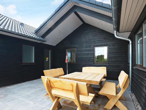a wooden table and chairs on a patio at 20 person holiday home in Højslev-By Traum in Højslev