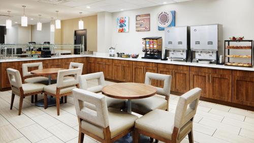 a restaurant with a table and chairs and a counter at Staybridge Suites Orlando Royale Parc Suites by IHG in Orlando