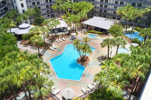 an aerial view of a resort pool with palm trees at Staybridge Suites Orlando Royale Parc Suites by IHG in Orlando
