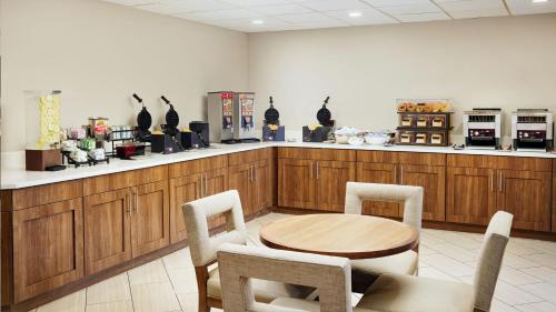 a restaurant with a table and chairs and a counter at Staybridge Suites Orlando Royale Parc Suites by IHG in Orlando