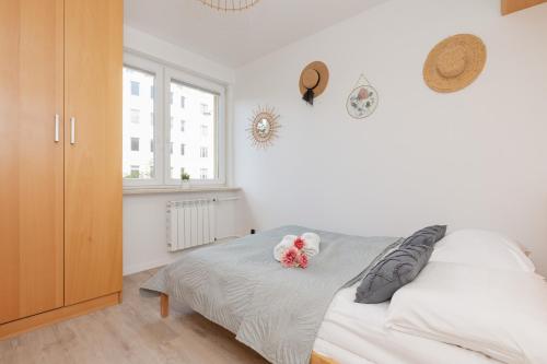 a bedroom with a bed with a teddy bear on it at Warsaw Stawki Cosy Apartment by Renters in Warsaw