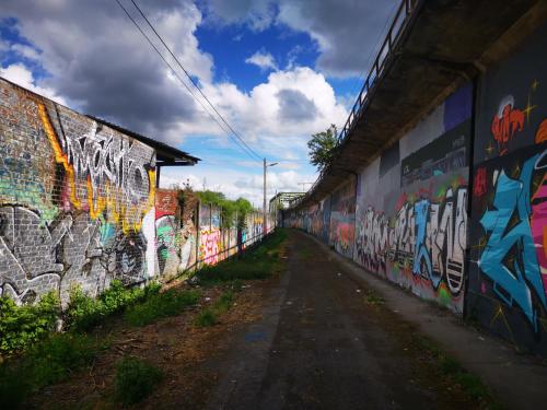 an alley with graffiti on the side of a wall at Adventure Alternative - GUEST HOUSE - Arts-Factory-Experience - For artists, makers and open minds - Attention, we are not a hotel and are not adapted for everybody - Read host warnings before reservation - PROVIDENCE,BE asbl in Charleroi