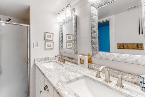 a white bathroom with a sink and a mirror at Pyramid V in Ocean City