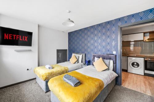 a hotel room with two beds with yellow cushions at The Countryman Corner - Smart TVs - Fast Wifi in Gillingham