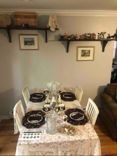 a dining room table with a table cloth on it at The Fallen Tree Inn in Geneva