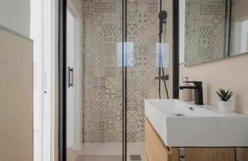 a bathroom with a white sink and a shower at Apartment close to the beach in Sant Adria de Besos