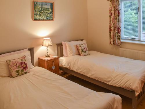 A bed or beds in a room at Beckside Cottage