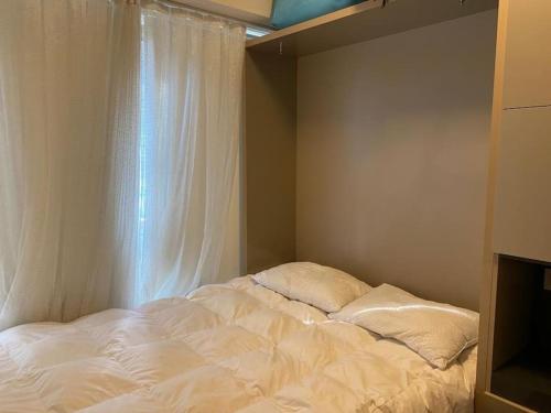 a white bed in a room with a window at apartment in the city center (NEF1+1) in Istanbul