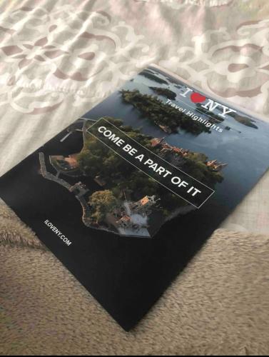 a magazine sitting on top of a bed at The Fallen Tree Inn in Geneva