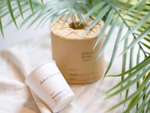 a bottle of moisturizing cream next to a plant at Super Hotel Tozai line Ichikawa Myoden Ekimae in Ichikawa