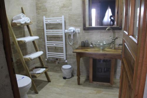 a bathroom with a sink and a toilet at Vigneron Cave Hotel in Nevsehir