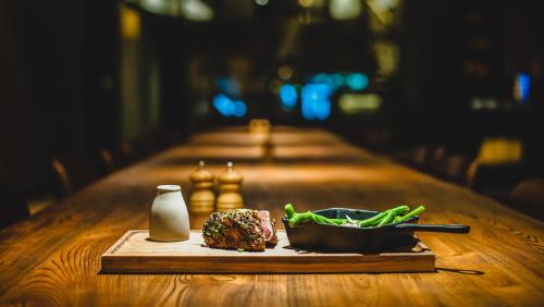 a table with a chess set and a plate of food at Holiday Inn Perth City Centre by IHG in Perth