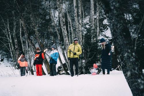 a group of people standing in the snow at Kinderhotel Stegerhof in Donnersbachwald